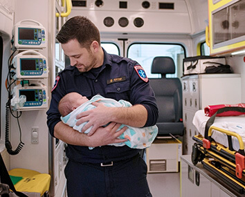 Ambulance with EMS and EMT caring for an infant Ambulance with EMS and EMT caring for an infant