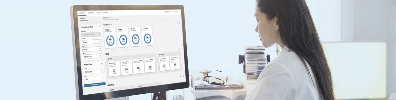 Healthcare professional viewing an RQI analytics dashboard on a computer monitor