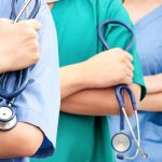 Doctors and nurses stand together in a hospital.