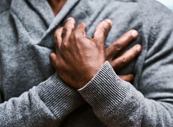 An older person experiencing chest pain