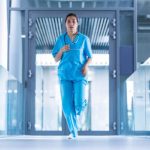 A nurse runs through the halls of a hospital to get to a critical CPR administration scenario.