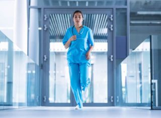 A nurse runs through the halls of a hospital to get to a critical CPR administration scenario.