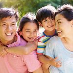 A family with small kids, smiling.