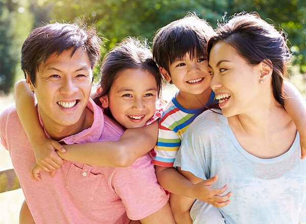 A family with small kids, smiling.