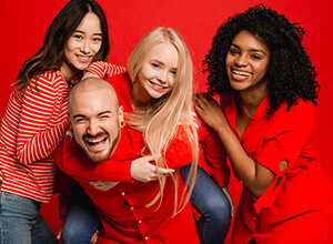 Four adults wearing red