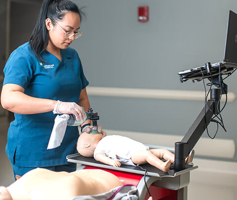 Nurse practicing CPR on RQI Station Nurse practicing CPR on RQI Station