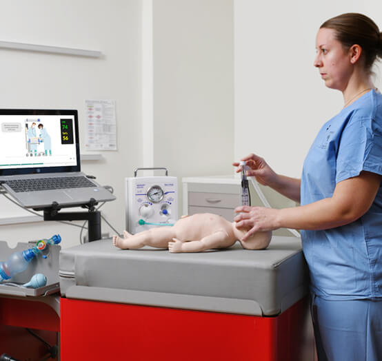 Nurse training and practicing infant CPR on a simulation mannequin